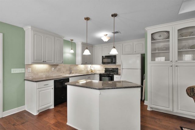 11445 Majestic Dr, Montgomery, TX 77316 - kitchen featuring visible vents, dark wood finished floors, a sink, black appliances, and white cabinetry