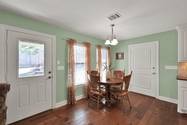 11445 Majestic Dr, Montgomery, TX 77316 - dining room with an inviting chandelier, baseboards, dark wood-style floors, and visible vents