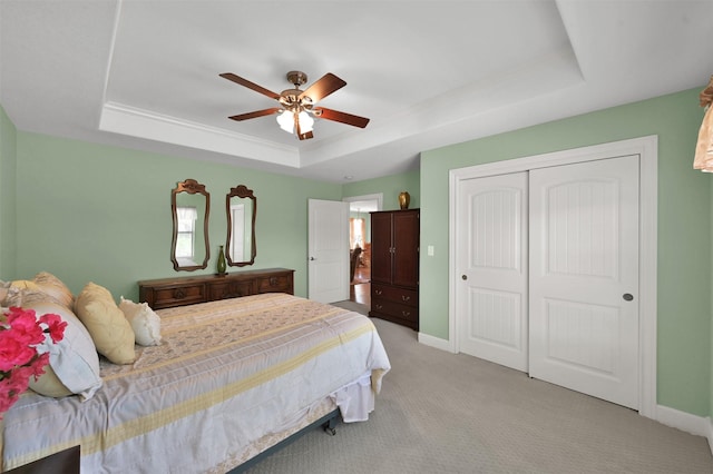 11445 Majestic Dr, Montgomery, TX 77316 - bedroom featuring a tray ceiling, light colored carpet, baseboards, and a closet