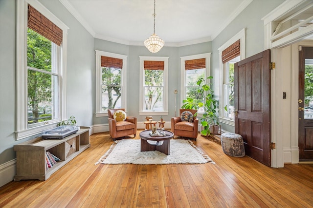 sunroom with plenty of natural light and a notable chandelier