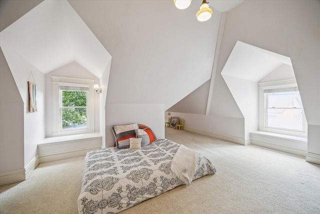 bedroom featuring baseboards, carpet flooring, and vaulted ceiling