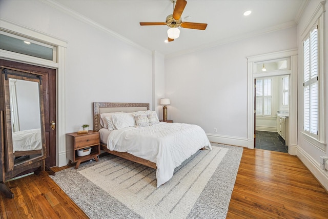 bedroom with wood-type flooring, ornamental molding, and multiple windows