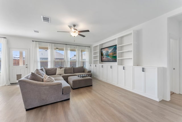23830 Via Leoni Dr, New Caney, TX 77357 - living room with a ceiling fan, light wood-type flooring, and built in features