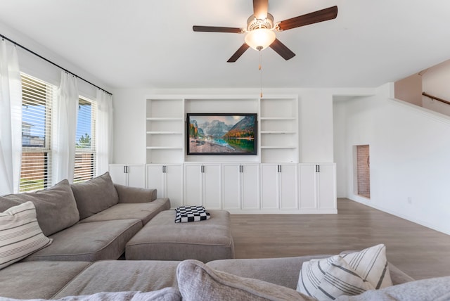 23830 Via Leoni Dr, New Caney, TX 77357 - living area with wood finished floors, a ceiling fan, built in shelves, and baseboards
