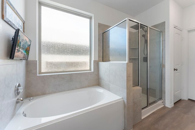 23830 Via Leoni Dr, New Caney, TX 77357 - full bath featuring a shower stall, a bath, and wood finished floors