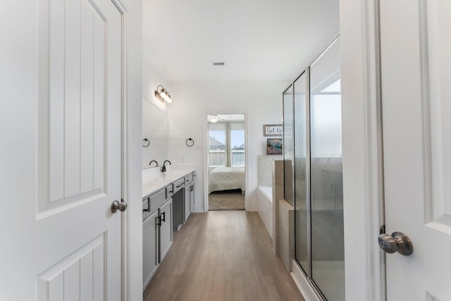 23830 Via Leoni Dr, New Caney, TX 77357 - full bath with wood finished floors, vanity, ensuite bathroom, and a shower stall