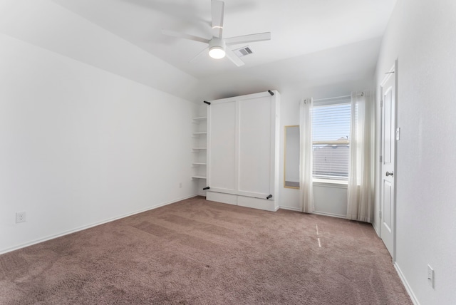 23830 Via Leoni Dr, New Caney, TX 77357 - unfurnished bedroom with light carpet, vaulted ceiling, a ceiling fan, and baseboards