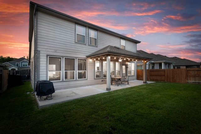 23830 Via Leoni Dr, New Caney, TX 77357 - back of property at dusk featuring a patio area