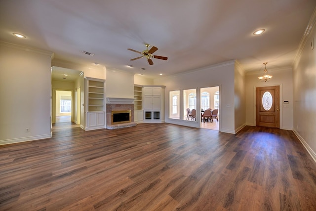 unfurnished living room with visible vents, ceiling fan with notable chandelier, ornamental molding, and a healthy amount of sunlight