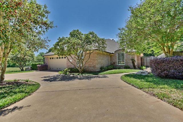 view of front of property featuring concrete driveway, a garage, fence, and brick siding