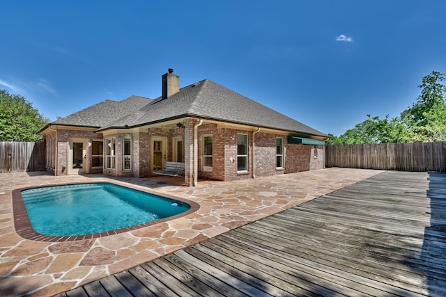 view of swimming pool with a patio area, a fenced backyard, and a wooden deck