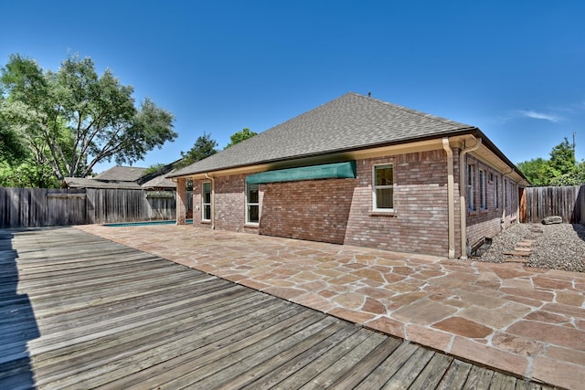 deck featuring a fenced backyard and a patio area