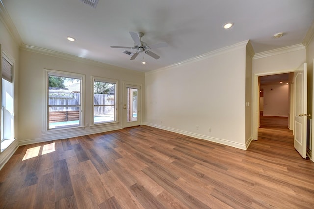 unfurnished room with crown molding, ceiling fan, light wood-style floors, and baseboards