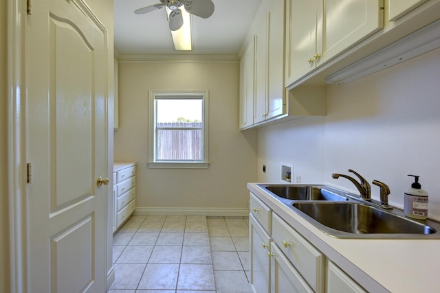 clothes washing area with hookup for an electric dryer, a ceiling fan, hookup for a washing machine, cabinet space, and a sink
