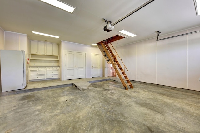 garage with a garage door opener and freestanding refrigerator