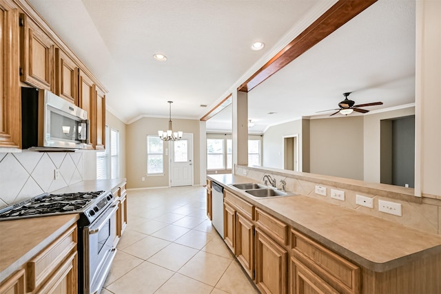 kitchen with crown molding, a sink, light tile patterned floors, backsplash, and appliances with stainless steel finishes