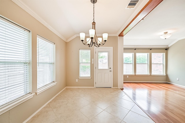 entryway featuring plenty of natural light, visible vents, and crown molding