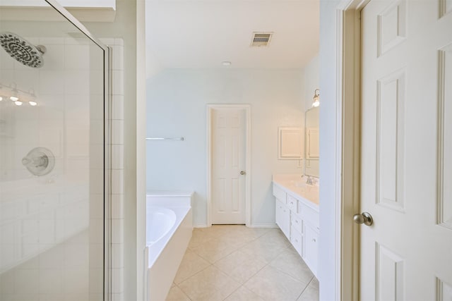 bathroom with a garden tub, a stall shower, vanity, baseboards, and tile patterned flooring