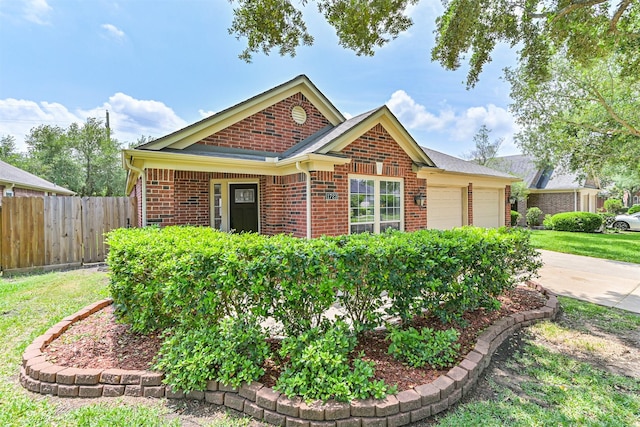 view of front of house with concrete driveway, an attached garage, brick siding, and fence