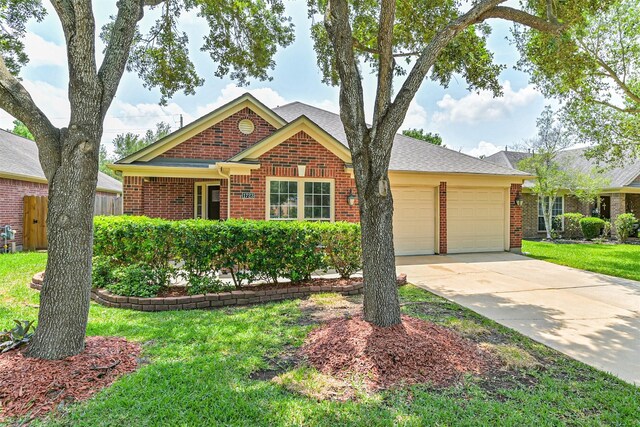 ranch-style house with an attached garage, brick siding, driveway, and a front lawn