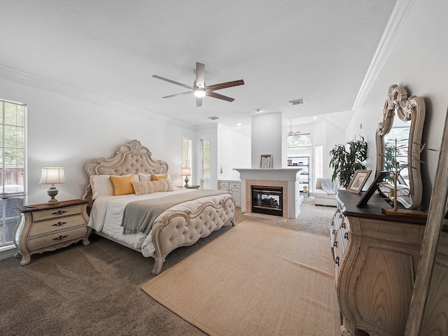 bedroom with light colored carpet, ornamental molding, visible vents, and a fireplace