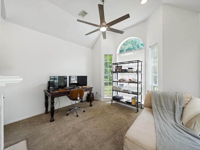 carpeted office space with high vaulted ceiling, a ceiling fan, and visible vents
