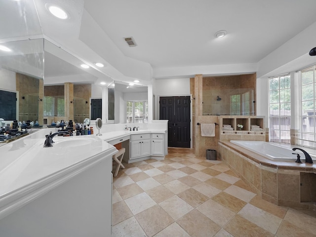 bathroom featuring a healthy amount of sunlight, a garden tub, visible vents, a shower stall, and recessed lighting