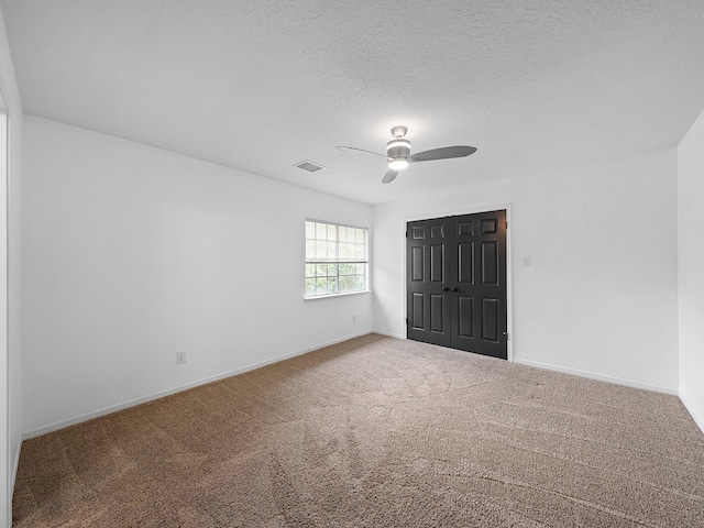 unfurnished bedroom with carpet flooring, baseboards, visible vents, and a closet