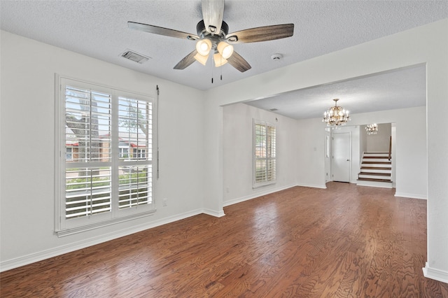 7 Colony Park Cir, Galveston, TX 77551 - spare room featuring a textured ceiling, stairway, visible vents, wood finished floors, and ceiling fan with notable chandelier