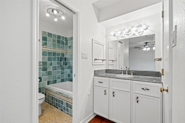 7 Colony Park Cir, Galveston, TX 77551 - bathroom with tiled shower / bath combo, tile patterned flooring, toilet, vanity, and a ceiling fan