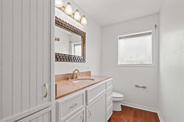 7 Colony Park Cir, Galveston, TX 77551 - bathroom with baseboards, wood finished floors, toilet, and vanity