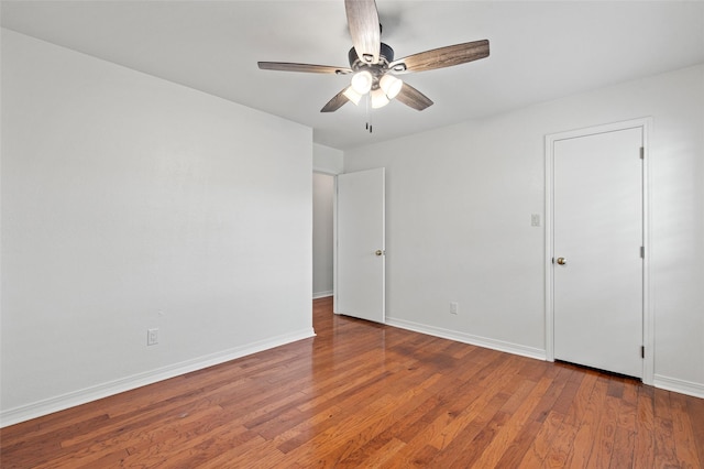 7 Colony Park Cir, Galveston, TX 77551 - unfurnished bedroom featuring baseboards, wood finished floors, and ceiling fan