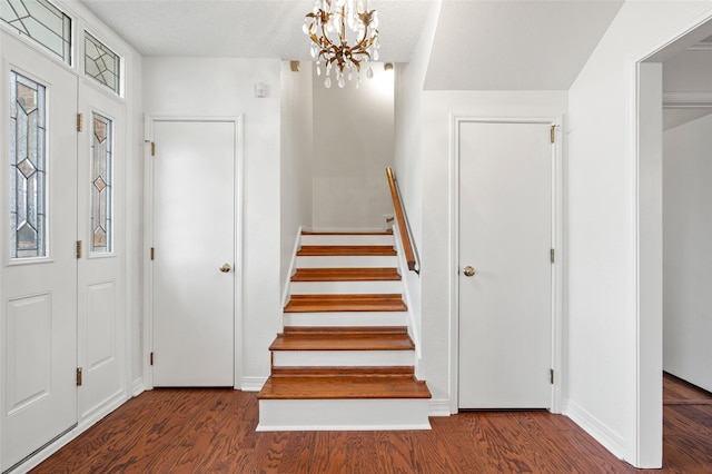 7 Colony Park Cir, Galveston, TX 77551 - foyer with stairs, an inviting chandelier, wood finished floors, and baseboards