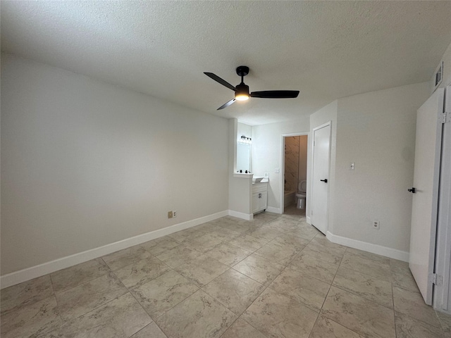 unfurnished bedroom featuring visible vents, baseboards, connected bathroom, and a textured ceiling