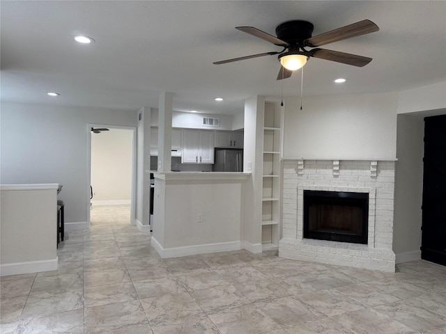 unfurnished living room with marble finish floor, a ceiling fan, a brick fireplace, and recessed lighting