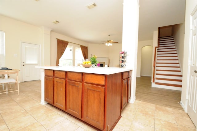 7214 Paradise Park Bnd, Richmond, TX 77407 - kitchen featuring light countertops, visible vents, a ceiling fan, light tile patterned floors, and arched walkways