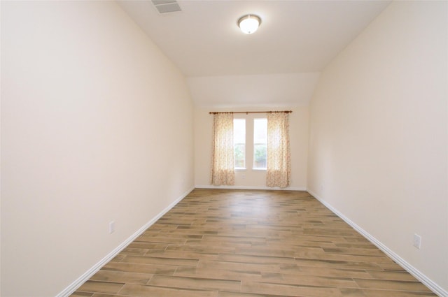 7214 Paradise Park Bnd, Richmond, TX 77407 - empty room featuring lofted ceiling, baseboards, and wood finished floors