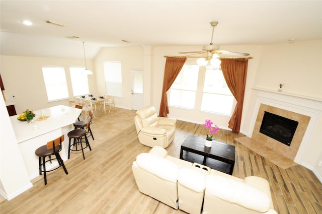 7214 Paradise Park Bnd, Richmond, TX 77407 - living room featuring light wood-style flooring, a ceiling fan, and a healthy amount of sunlight