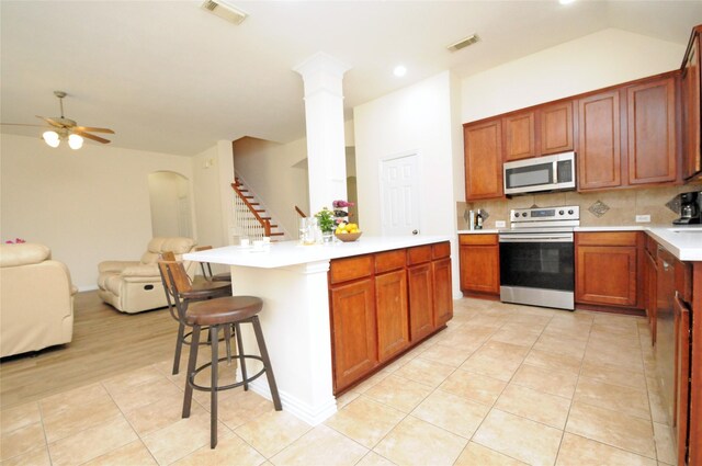 7214 Paradise Park Bnd, Richmond, TX 77407 - kitchen featuring open floor plan, backsplash, appliances with stainless steel finishes, and visible vents