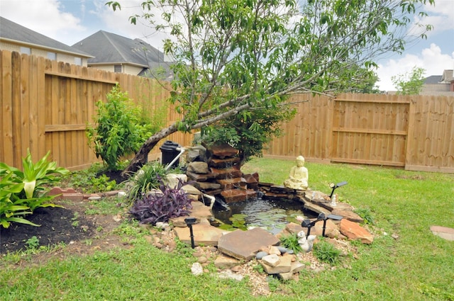 7214 Paradise Park Bnd, Richmond, TX 77407 - view of yard with a garden pond and a fenced backyard