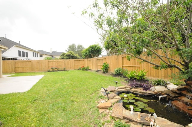 7214 Paradise Park Bnd, Richmond, TX 77407 - view of yard featuring a fenced backyard, a patio, and a small pond
