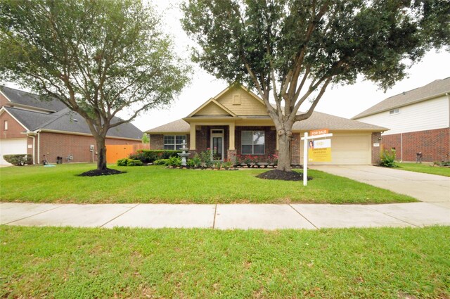 7214 Paradise Park Bnd, Richmond, TX 77407 - view of front of house featuring concrete driveway, a front lawn, brick siding, and a garage