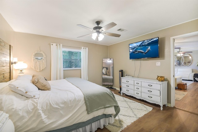 27011 Azalea Ct, Magnolia, TX 77354 - bedroom with ceiling fan, wood finished floors, and visible vents