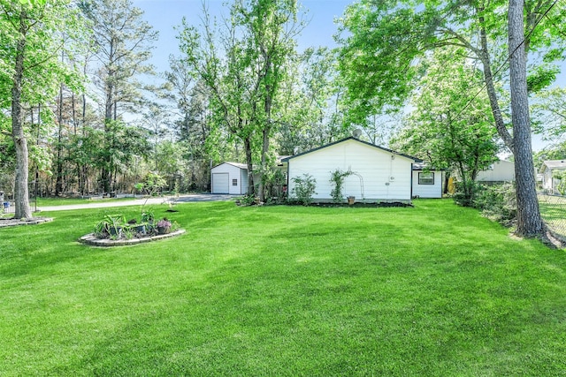 27011 Azalea Ct, Magnolia, TX 77354 - view of yard with fence, an outbuilding, a detached garage, and driveway