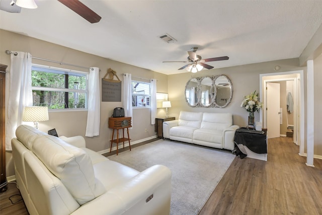 27011 Azalea Ct, Magnolia, TX 77354 - living room featuring wood finished floors, baseboards, a ceiling fan, and visible vents