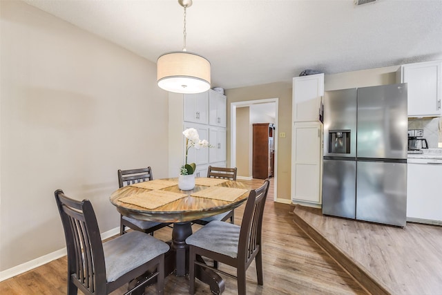 27011 Azalea Ct, Magnolia, TX 77354 - dining room featuring baseboards and wood finished floors