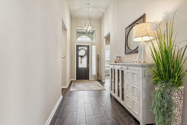 1919 Hickory Grove Ln, Tomball, TX 77375 - foyer entrance with a high ceiling, an inviting chandelier, baseboards, and wood finish floors