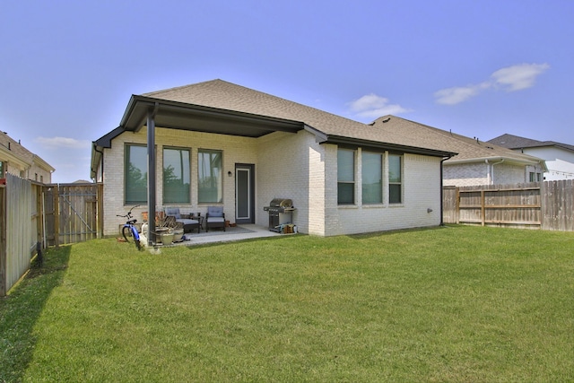 1919 Hickory Grove Ln, Tomball, TX 77375 - back of house with a fenced backyard, a lawn, a patio, brick siding, and a shingled roof