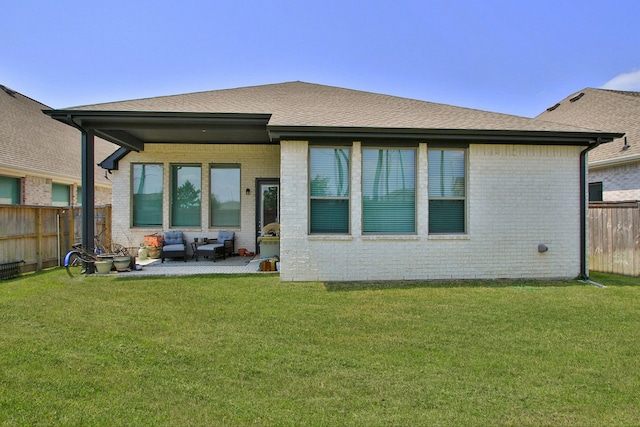 1919 Hickory Grove Ln, Tomball, TX 77375 - back of property featuring a shingled roof, a yard, a patio area, fence, and brick siding