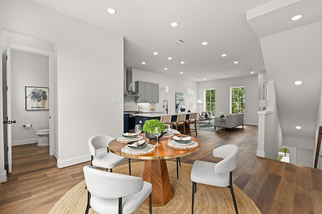 dining space featuring baseboards, recessed lighting, and light wood-style floors